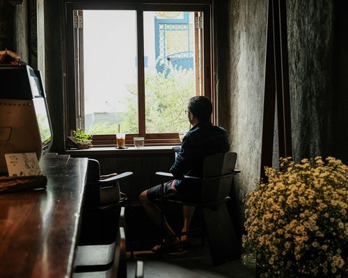 Person looking out the window taking a break from computer