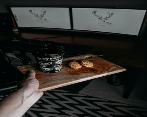Cup of coffee and an open notebook on a wooden desk